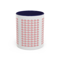 White mug with pink elephant pattern and navy interior on a white background