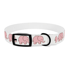Happy golden retriever wearing pink elephant dog collar during sunny park walk